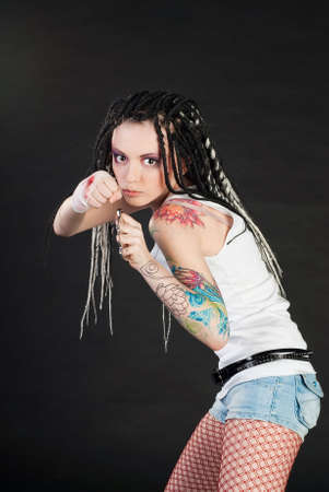 beauty girl with knuckleduster and with body art on her handの写真素材