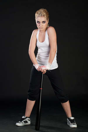 white girl fighter with baseball bat on black backgroundの写真素材