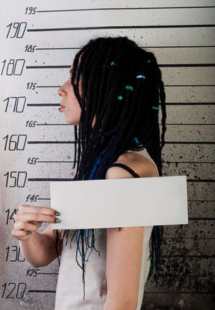 white girl in prison with injuries on ruler background. profile photoの写真素材