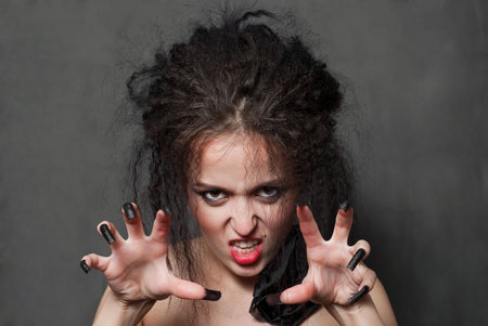 beauty young witch with black nails conjures on black backgroundの写真素材