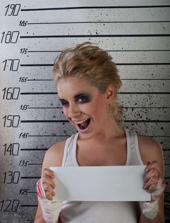 white girl wink  in prison with injuries on ruler backgroundの写真素材