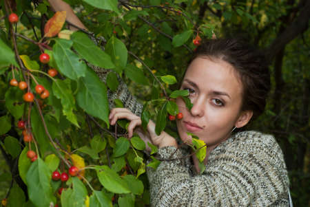 beauty girl stay near leaves of the wild apple treeの写真素材