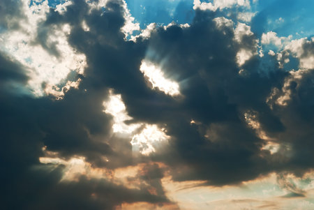rays of light breaking through the dark cumulus cloudの写真素材