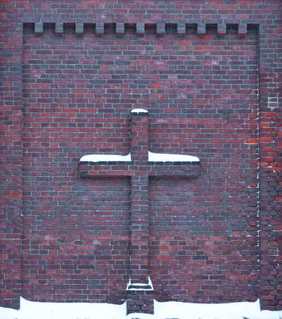 brick cross in wall of red brickの写真素材