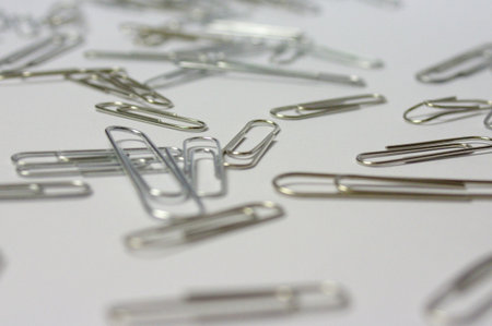 Paper clips on a white background in and out of focus
