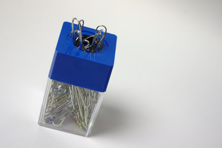 Paper clips on a white background in a container
