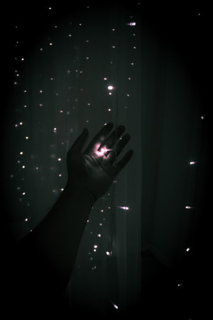 Holding a little light in the darkの写真素材