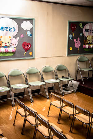Neatly arranged wooden benches for children in kindergartenの写真素材