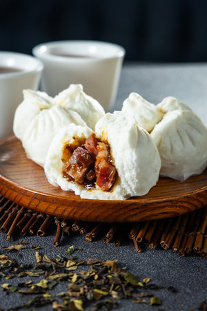 a traditional Hong Kong teahouse featuring classic dim sum delights like char siu bao and a warm cup of Chinese teaの写真素材