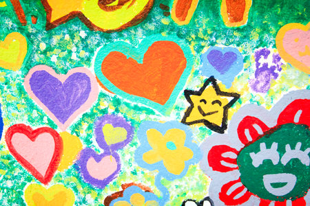 A joyful mural with hearts, flowers, smiling star, and expressive textures in green and yellow tones.の写真素材