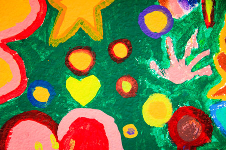 A vibrant mural with yellow star, pink handprint, yellow heart, and colorful abstract flower-like shapes.の写真素材