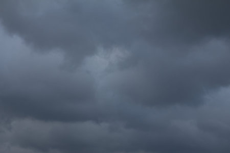 Thick, layered clouds dominate the sky, creating a dramatic and foreboding atmosphere indicator of...