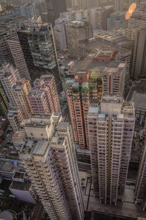 A bird's-eye view of a dense urban area with colorful buildings, rooftops, and visible...