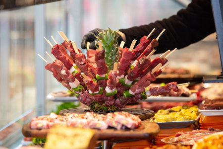 Meat department, showcase with variety of meat in different cuts. Inside an supermarket. Different types of fresh meat arranged in an orderly mannerの写真素材