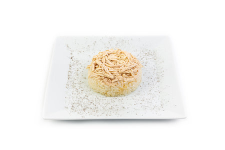 rice with chicken on a white plate isolated on a white background.の素材