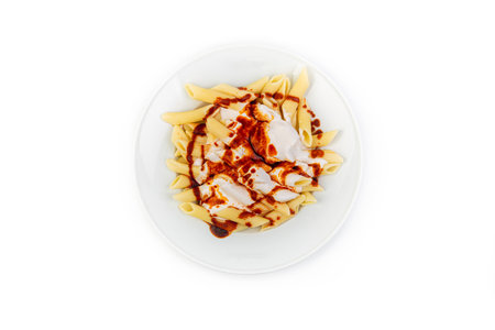 Pasta with cream sauce on a white plate isolated on white backgroundの素材