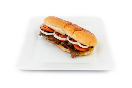 Hamburger with beef, tomato and onion on a white plateの素材