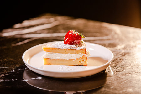 Strawberry cheesecake on white plate. selective focus.の素材