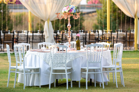 Table set for an event party or wedding reception in a park.の素材
