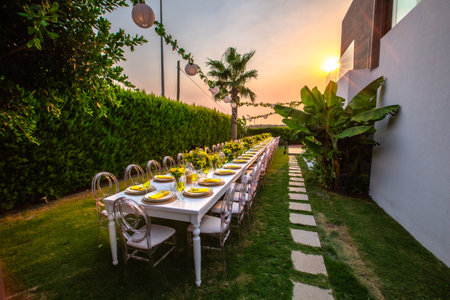 Wedding table setting in the garden at sunset, Thailand.の素材