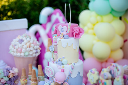 Wedding cake pops with colorful balloons and ice cream on topの素材