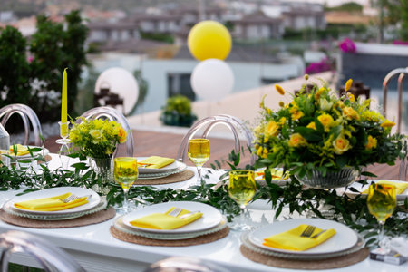 Wedding table setting with yellow tablecloth and yellow napkinsの素材