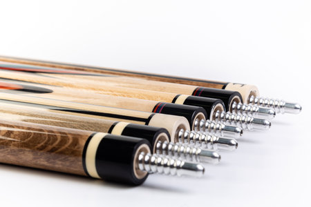 Wooden sticks for billiards on a white background, close-upの素材
