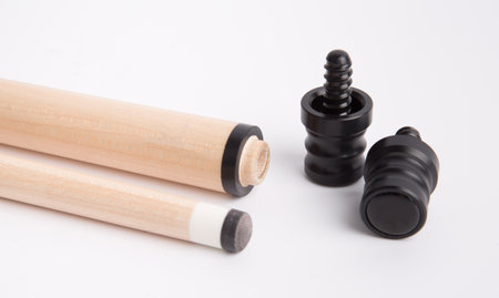 Wooden drumsticks and black plastic drum set on white background.の素材