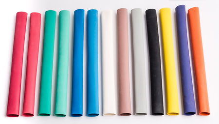Colored plastic pipes on a white background. selective focus.の素材