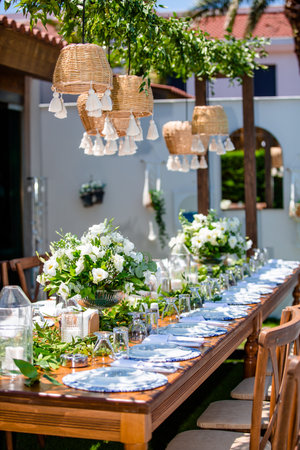 Wedding table set up for a romantic dinner in the gardenの素材
