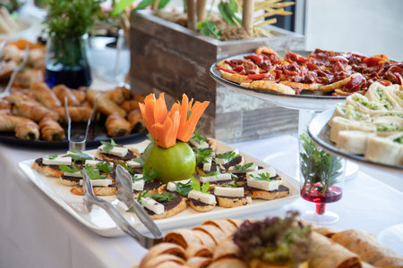 Catering buffet with variety of food snacks and appetizers.の素材