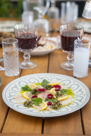 Close up of a plate of salad with pesto sauce and lemonの写真素材