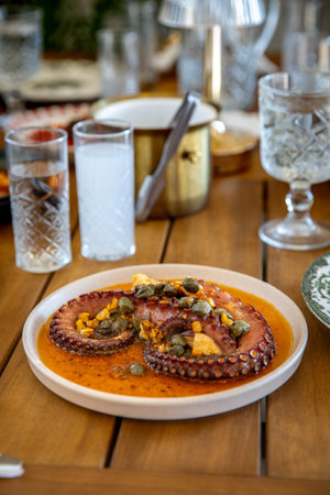 Seafood stewed in tomato sauce with pumpkin seeds and capersの写真素材