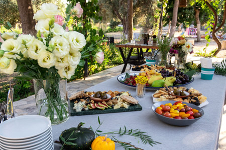 Wedding table setting in the garden with a variety of fruits and vegetables