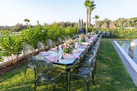 Outdoor wedding ceremony setting with chairs, table and tablecloth.の写真素材