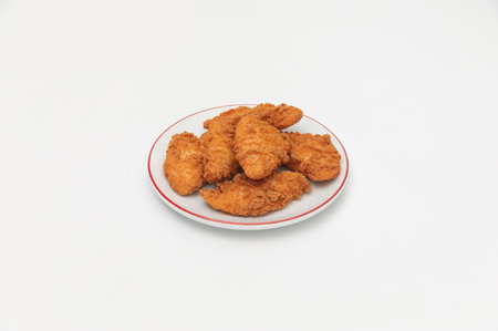 Fried chicken nuggets on a plate on a white background.の写真素材