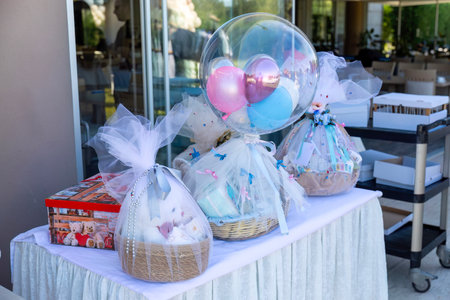 Basket with gifts and balloons on a table in a restaurant.の写真素材