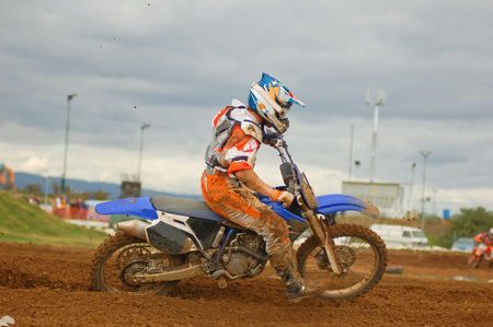 Motocross rider going hard out of the corner
