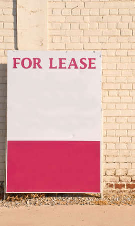 For lease sign against a neutral brick wallの写真素材