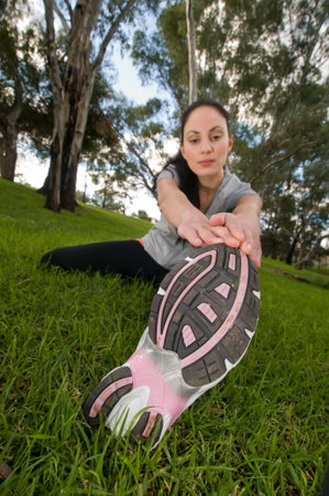 Young woman performing stretching exercises. 