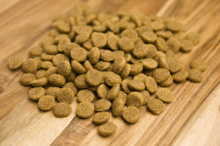 Dry dog food biscuits on a wooden chopping board