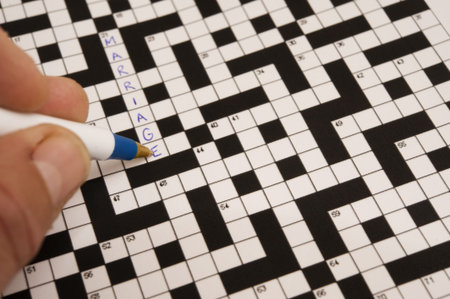 Writing the word marriage on a crossword puzzleの写真素材