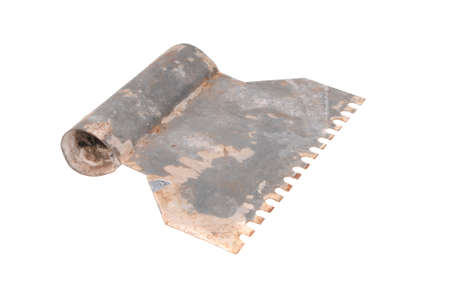A vintage metal tile adhesive spreader isolated on a white backgroundの写真素材