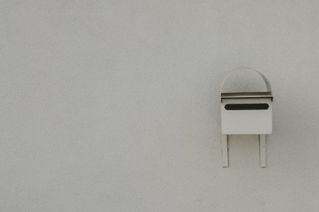 A Gray letterbox on a rendered gray wall with plenty of copyspaceの写真素材