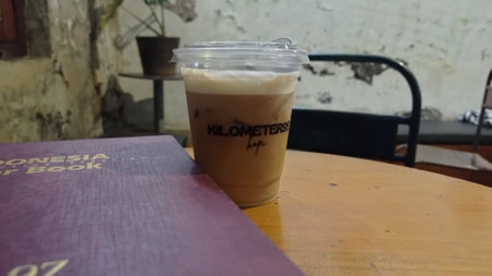 Iced latte coffee on wooden table in coffee shop background.の写真素材