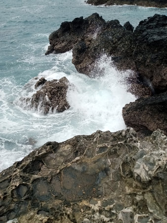 Tropical ocean waves crashing on the rocks in Hawaii, USAの写真素材