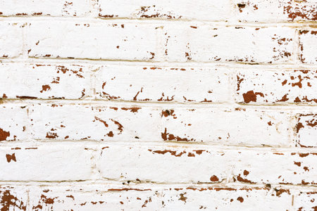 Background of an old vintage dirty brick wall with fallen off plaster. Texture.