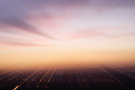 The sunset in the city lights blends into the sky.の写真素材