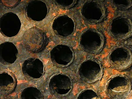 A collection of rusty black pipes.の写真素材