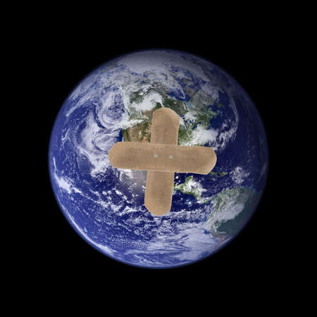 A picture of the earth with two band-aids forming a cross. Earth picture is taken from NASA.の写真素材